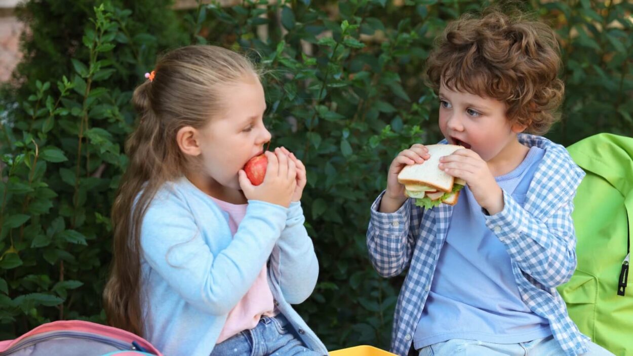 two kids eating outside