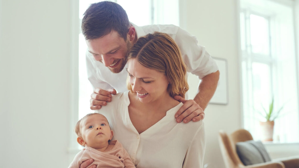 Two parents looking at a a baby