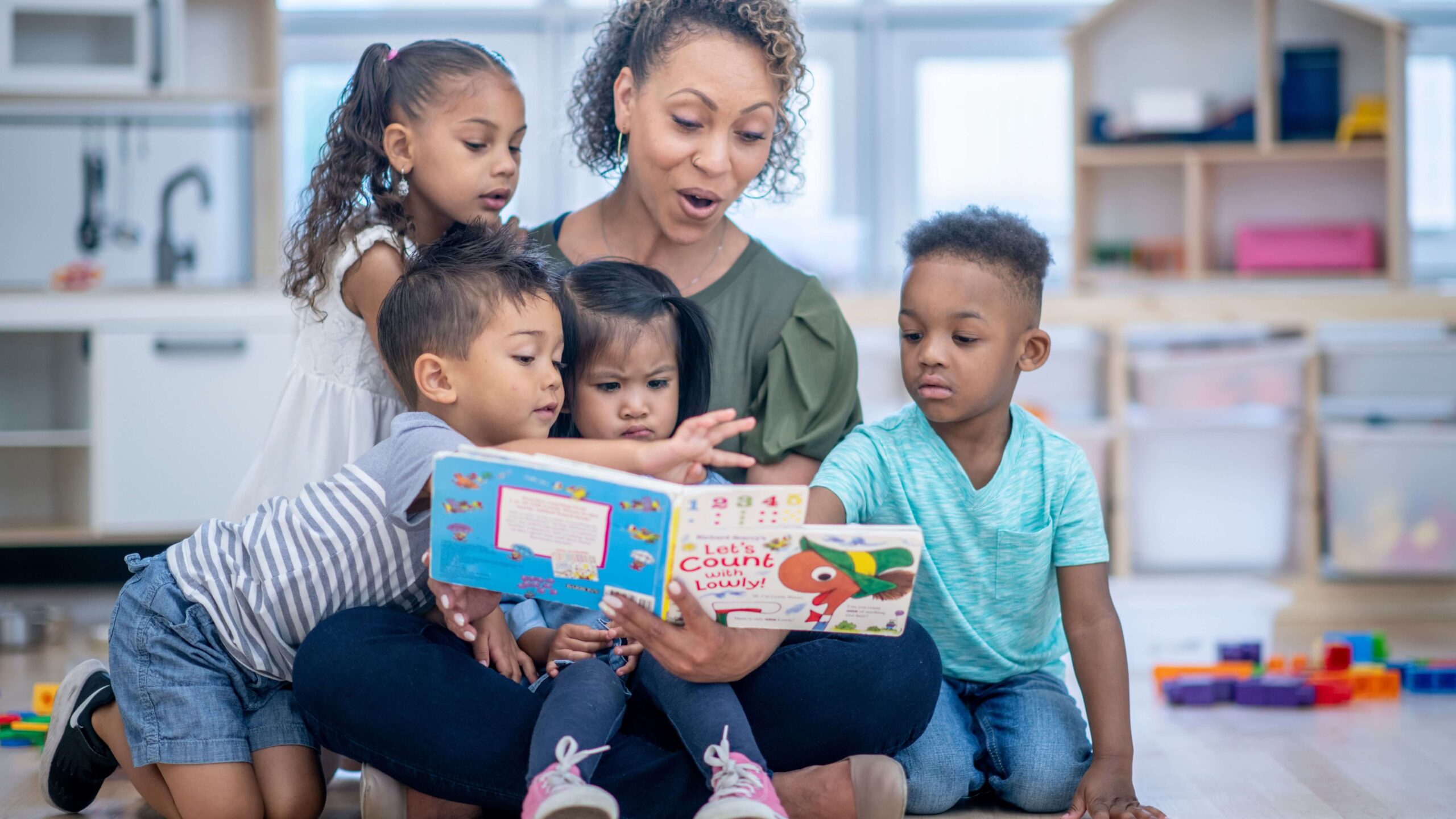 Daycare teacher reading to students