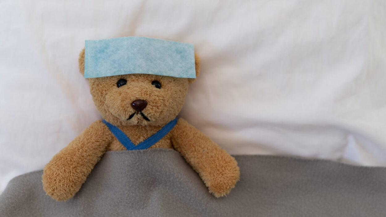 sick teddy bear in bed