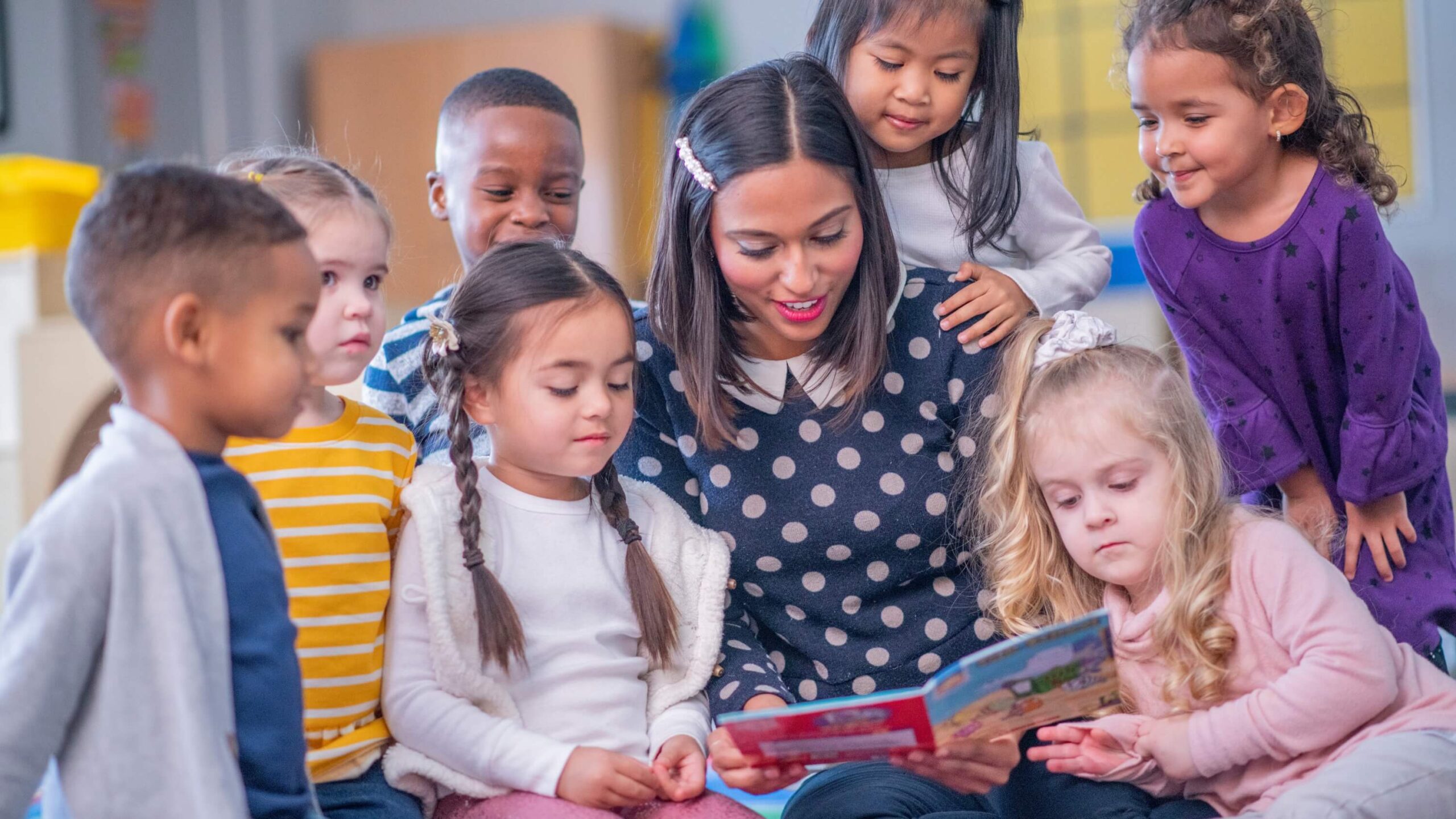 teacher reading to a group of kids