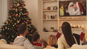 Family sitting on the couch watching a Christmas movie
