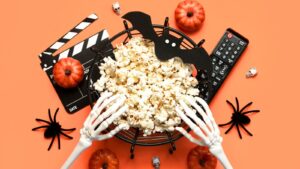 Skeleton hands reaching for popcorn