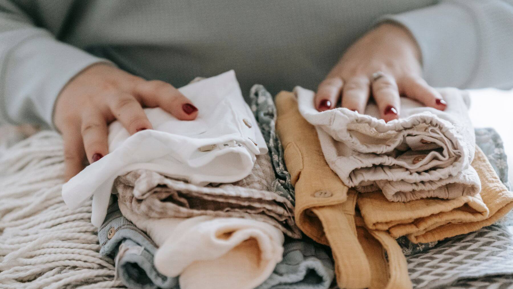close up of person packing clothes close up of person packing clothes