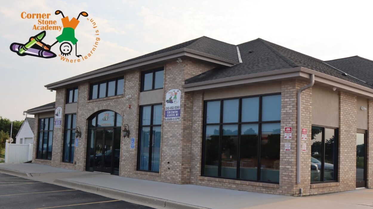 Corner Stone Academy brick building exterior with colorful school logo